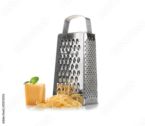 Metal grater and piece of cheese on white background