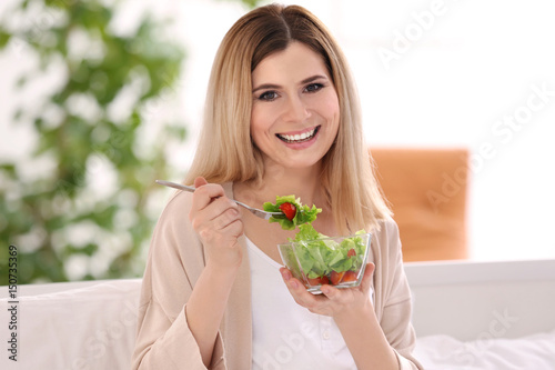 Young woman having breakfas...