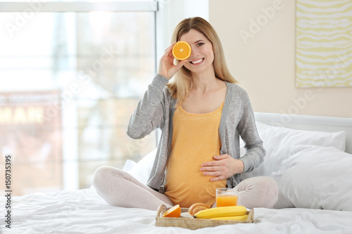 Young pregnant woman having...