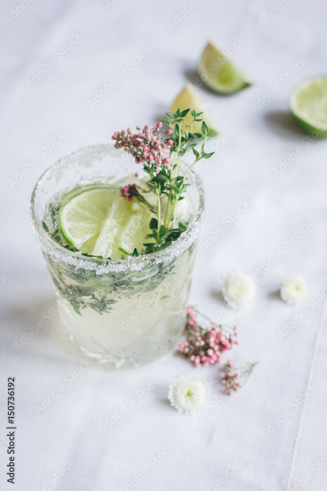 summer homemade juice with lime and blossom on stone table background summer homemade juice with lime and blossom on stone table background