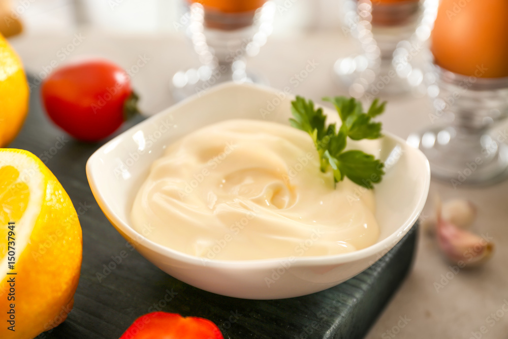 Delicious mayonnaise in bowl on kitchen table, closeup Delicious mayonnaise in bowl on kitchen table, closeup