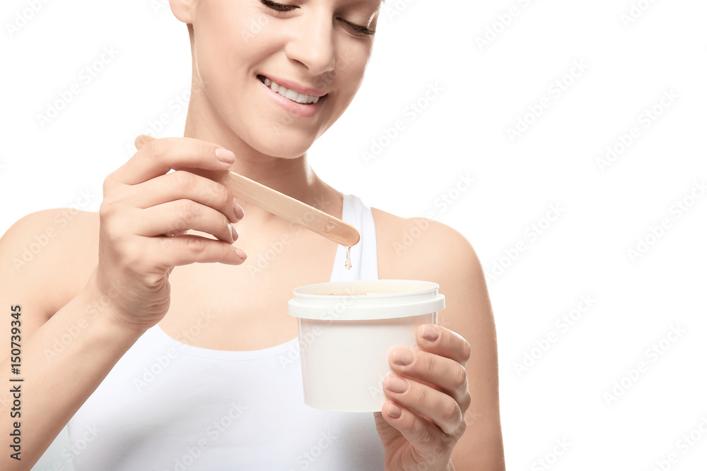 Beautiful young woman preparing for wax epilation on white background Beautiful young woman preparing for wax epilation on white background