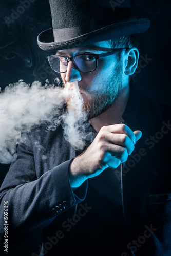 The man smoke an electronic...