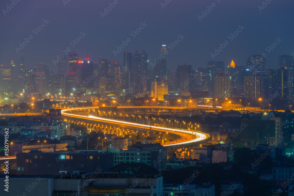 Aerial view of a city skylines and the highway heading into the Bangkok city at night.
