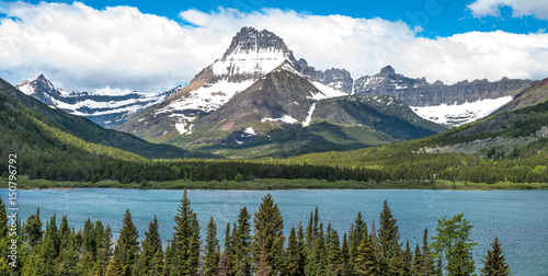 Mount Wilbur - A panoramic spring view of Mount Wilbur towering at side of Swiftcurrent Lake in Many Glacier region of Glacier National Park, Montana, USA.