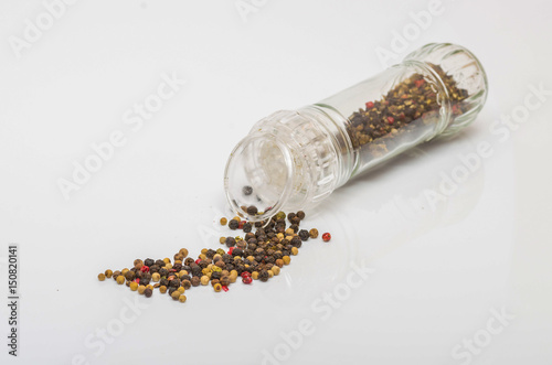 Fragrant black pepper on a white background, this is a common spice with useful properties obtained from seeds of plants of the genus Pepper