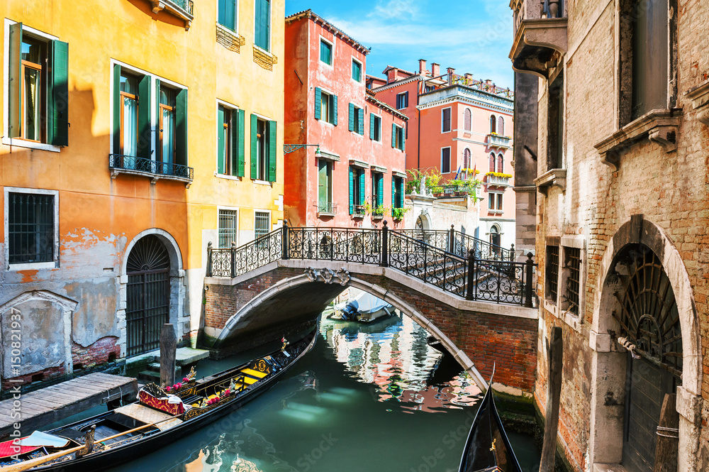 Scenic canal with bridge and colorful buildings in Venice, Italy