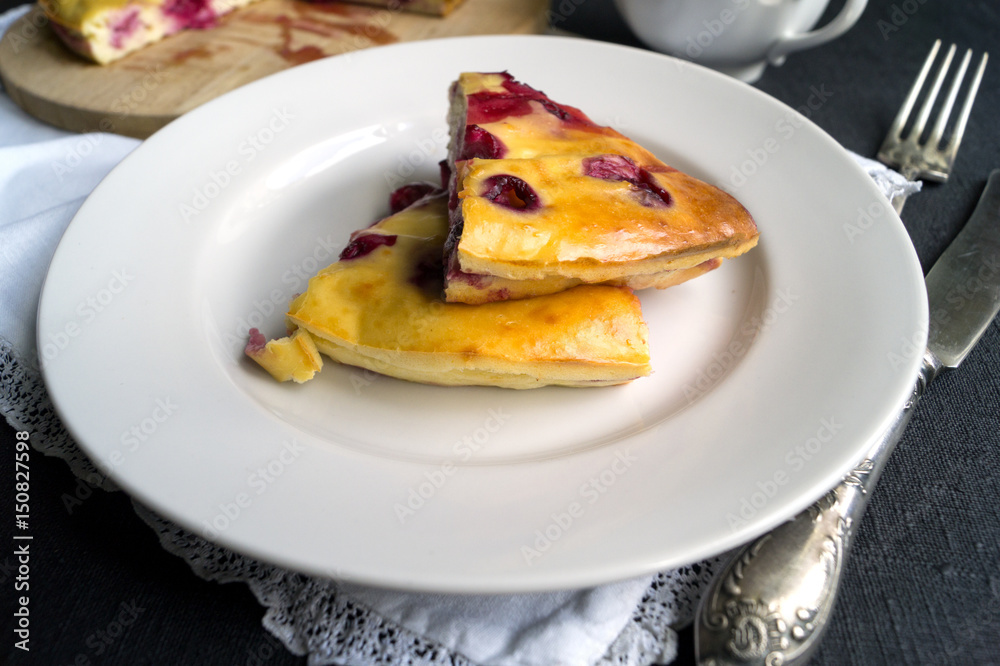 Cheesecake with berries, cherries. on a white plate Cheesecake with berries, cherries. on a white plate