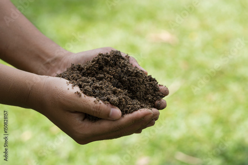 Farmer hands holding the soil.