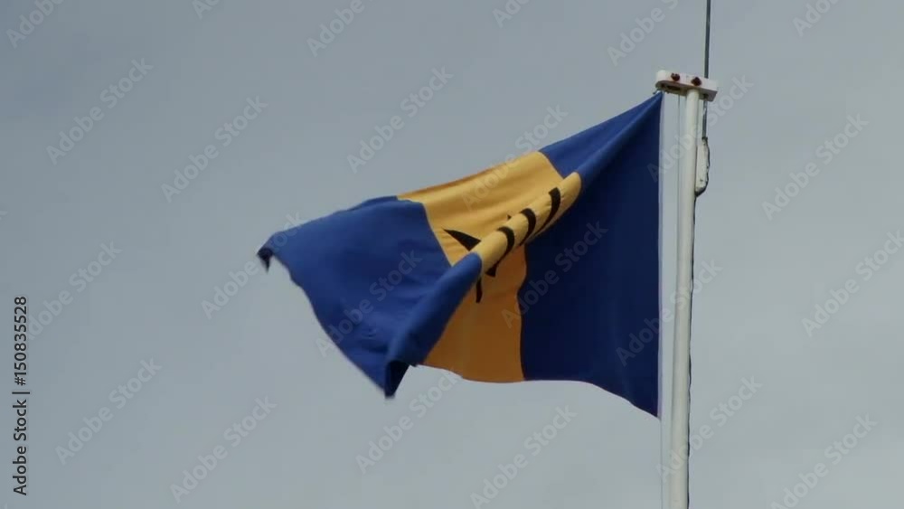 National flag of Barbados flying in the wind on Parliament building in Bridgetown