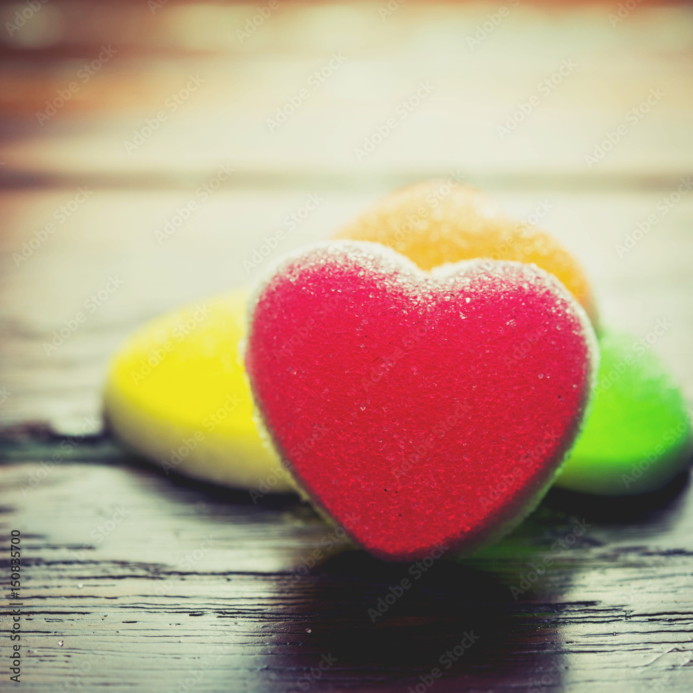 Fototapeta premium Heart candies coated with sugar, heart colorful sweet candies, sugar heart shaped candy