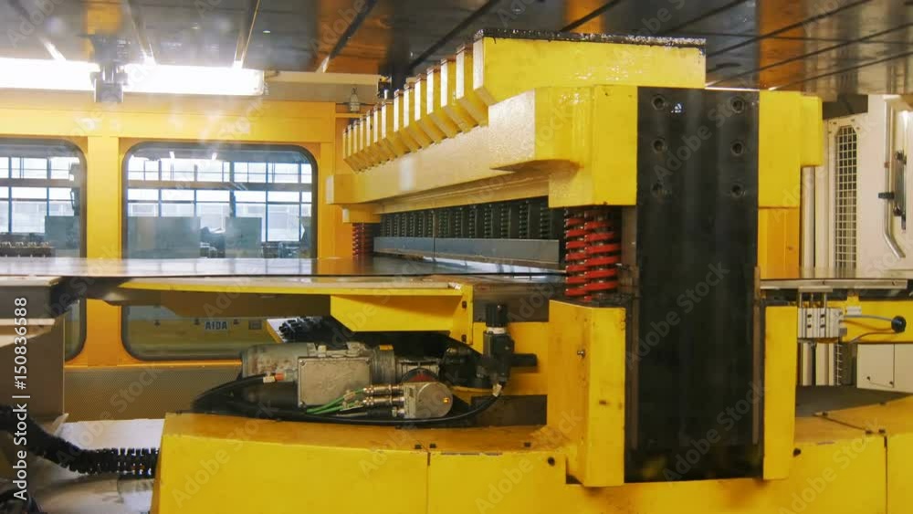 view on press cutting machine on a car factory, robotic production of detail for cars view on press cutting machine on a car factory, robotic production of detail for cars