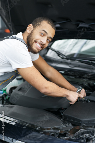 Professional car mechanic repairing a car