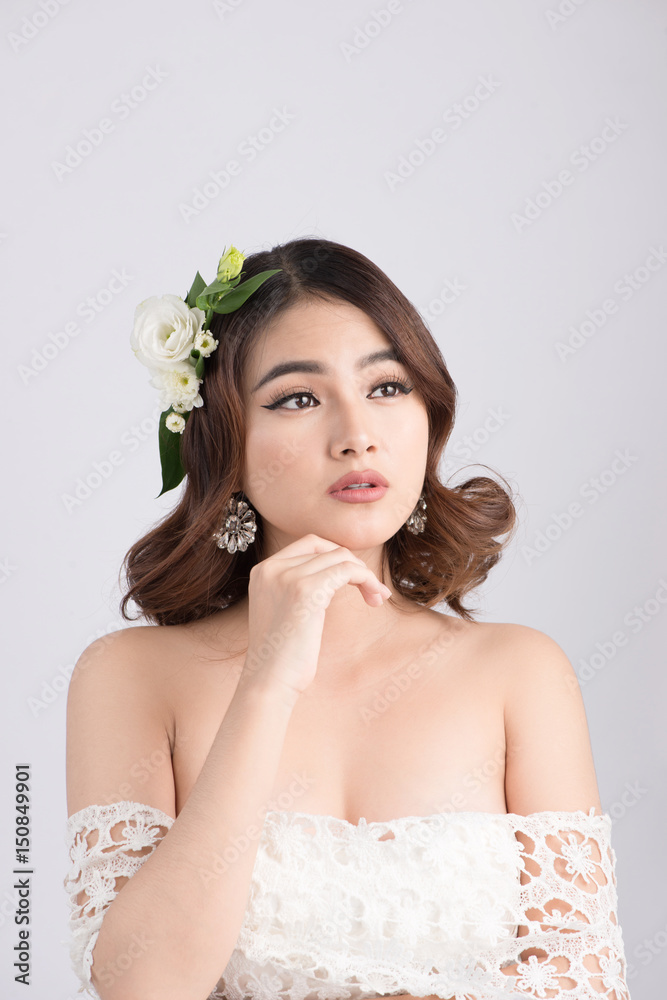 Beautiful asian woman bride on grey background. Closeup portraits with a professional makeup Beautiful asian woman bride on grey background. Closeup portraits with a professional makeup