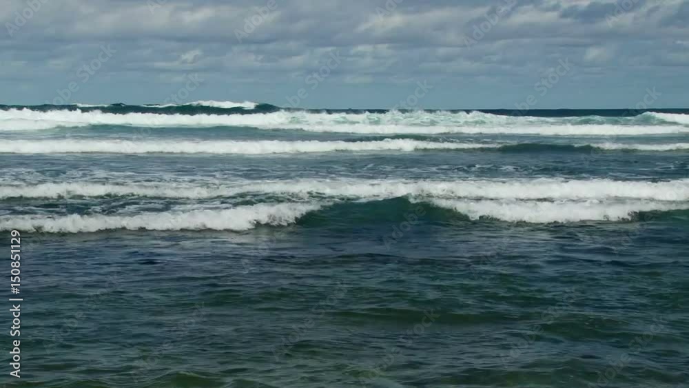 Dramatic shot of white waves crashing on the beach of Barbados Dramatic shot of white waves crashing on the beach of Barbados