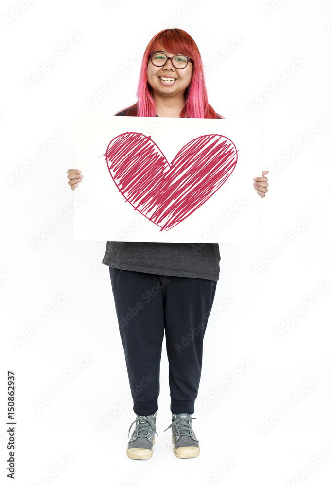 Young hipster girl holding heart icon on board Young hipster girl holding heart icon on board