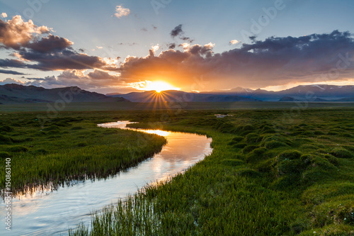 Beautiful sunset over the mountain river in summer