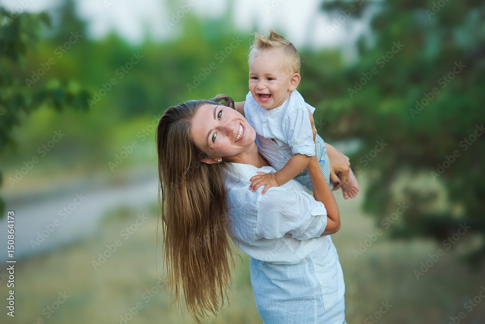 Fototapeta premium happy mother playing with her son in the park