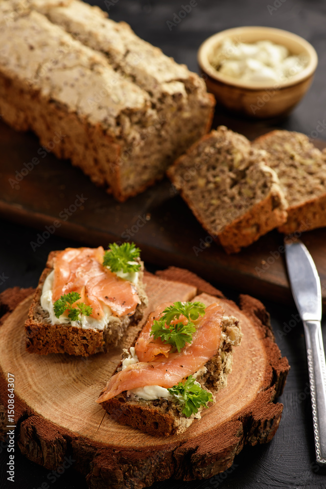 Homemade bread and sandwiches with salmon and cheese.