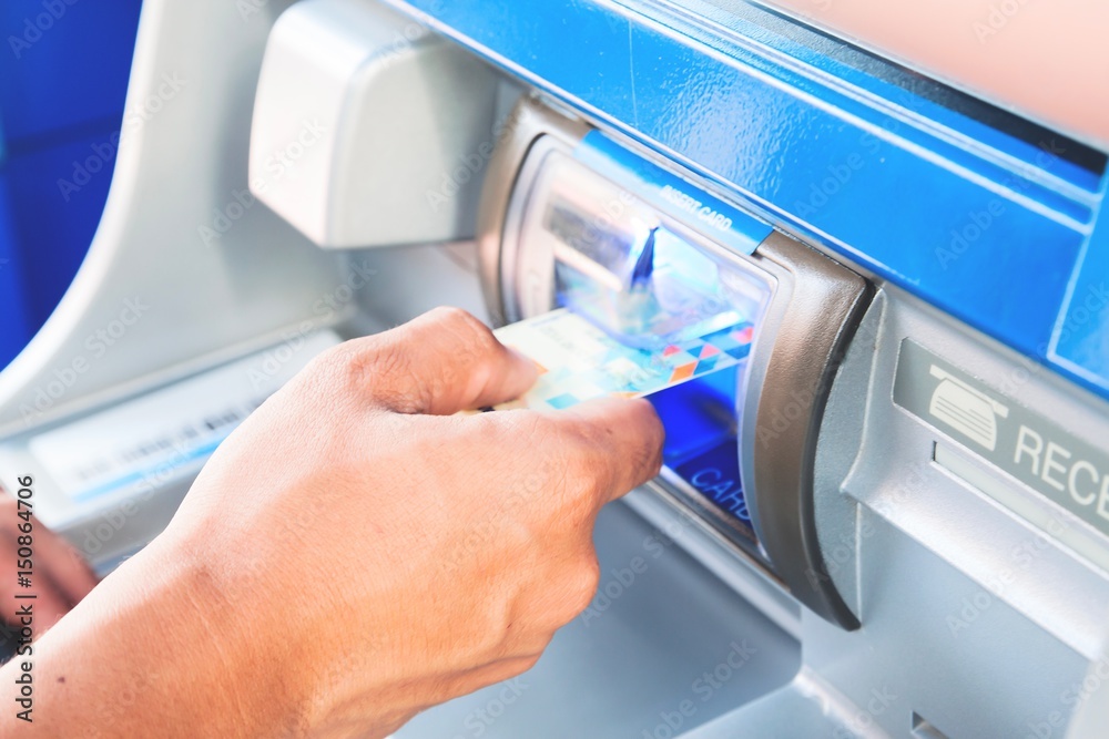 Hand of man insert card to atm machine Hand of man insert card to atm machine