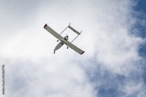 Unmanned aerial vehicle (UAV) in blue sky.