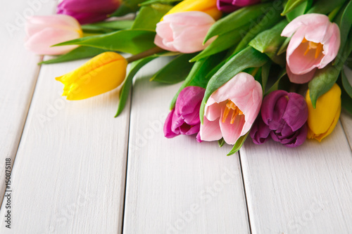 Fototapeta Naklejka Na Ścianę i Meble -  Bright tulips bouquet on white wood background, copy space