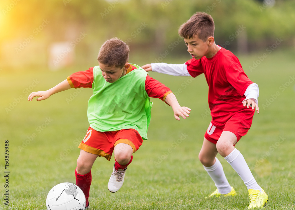 Kids soccer football - children players match on soccer field Kids soccer football - children players match on soccer field