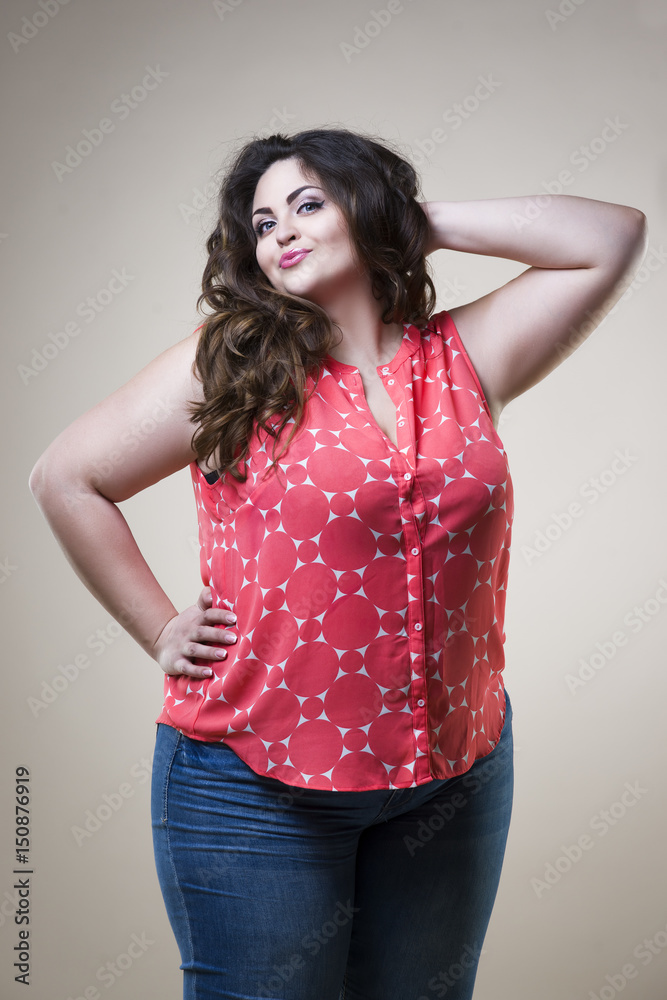 Plus size fashion model in casual clothes, fat woman on studio background,  overweight female body Stock Photo