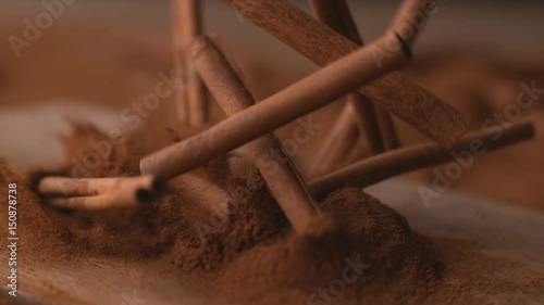 Cinnamon sticks falling into powdered cinnamon in super slow motion, shot on Phantom Flex  photo