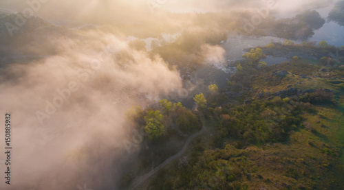Aerial View. Sunrise at the river. Morning misty landscape with sunlight and rapids.