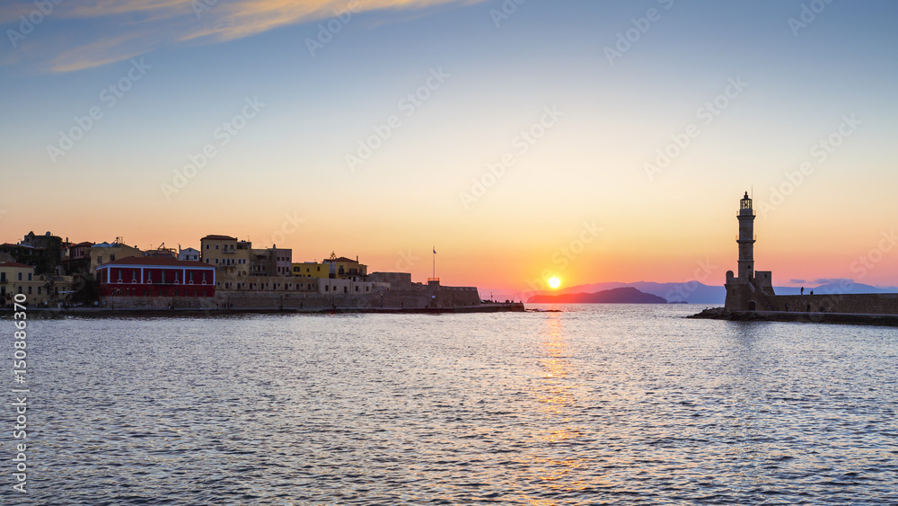 Lighthouse in the mouth of the old Venetian harbor of Chania town in Crete , Greece. 
