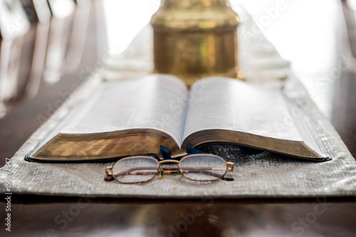 Reading the Bible Daily with Study glasses and magnify glass 