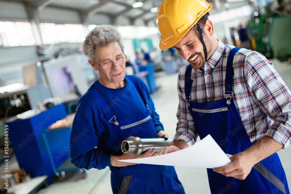 Supplier with engineer checking on production in factory