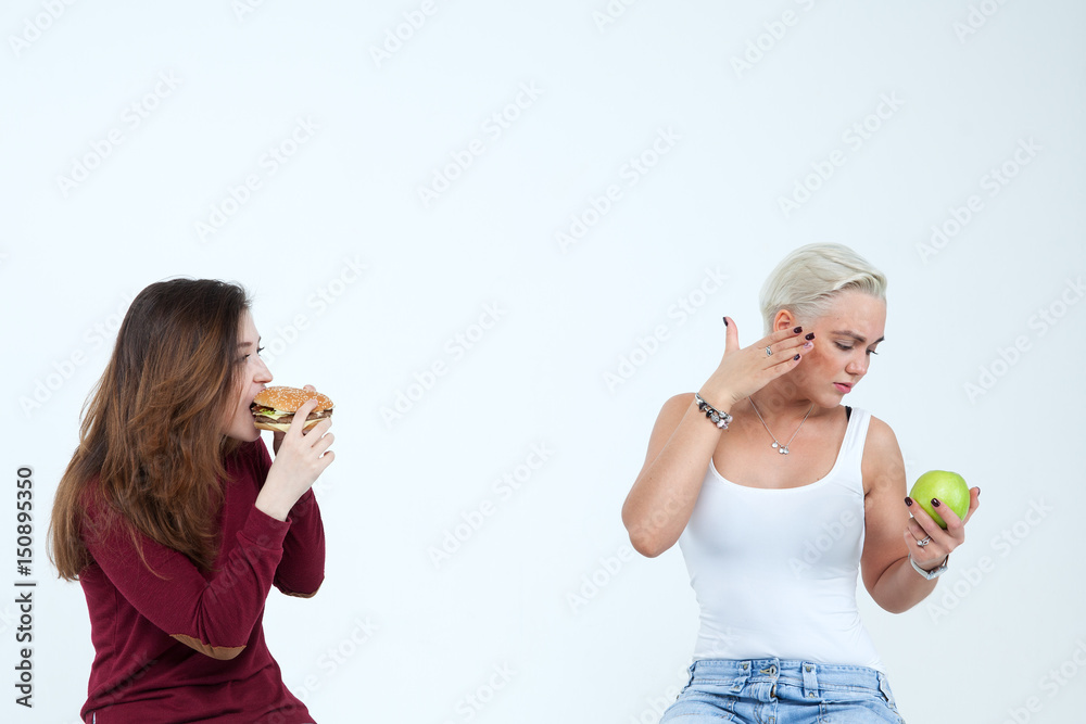 Girls with an apple and a hamburger