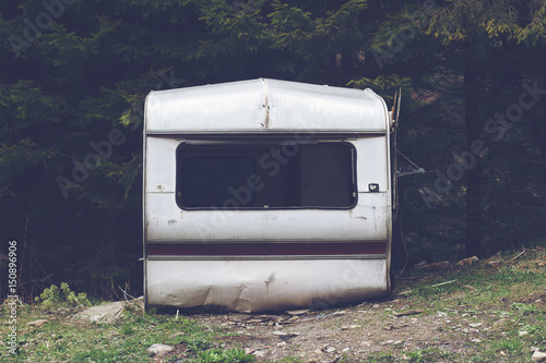 damaged car trailer in the woods