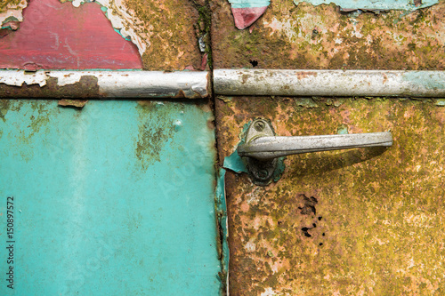 Close up of an antique old rusted  blue car door photo