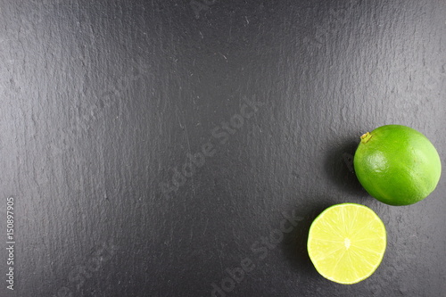 fresh lime fruit on a slate plate food background texture photo