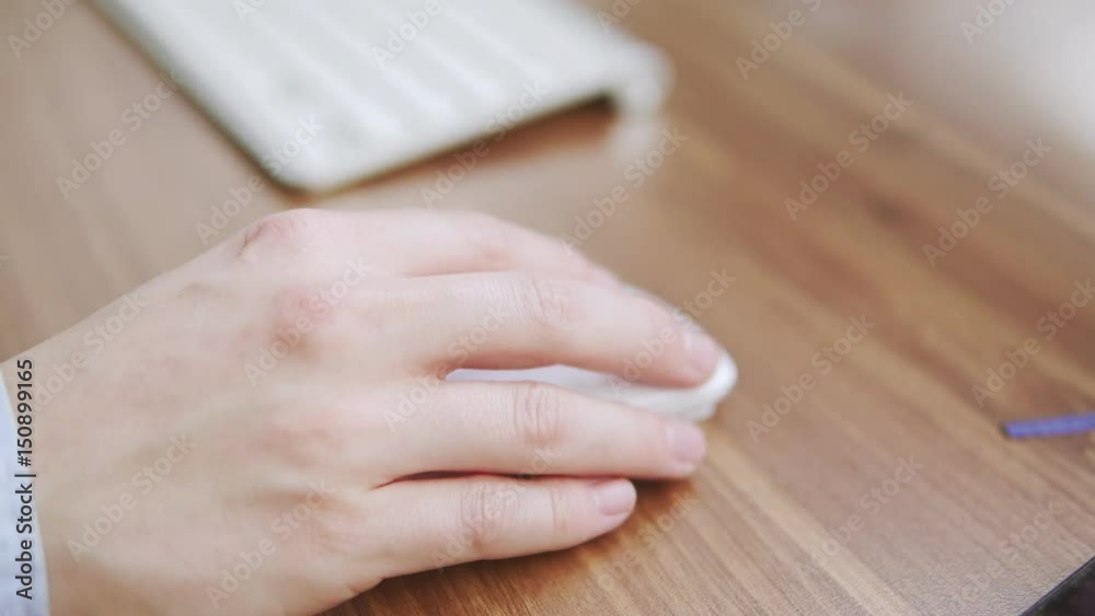 Top view of a young man's hand using computer mouse sitting at the table in the office. Young worker using mobile phone, computer keyboard and mouse. Wood table desktop. Shot from above in 4k Top view of a young man's hand using computer mouse sitting at the table in the office. Young worker using mobile phone, computer keyboard and mouse. Wood table desktop. Shot from above in 4k