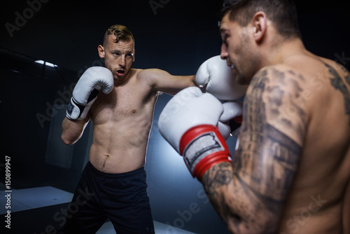 Professional boxer training with left hits