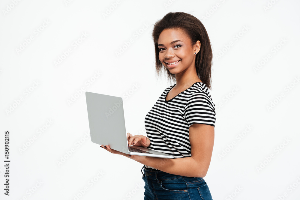 Happy young african woman using laptop computer. Happy young african woman using laptop computer.