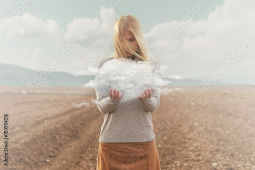 surreal moment , woman holding in her hands a soft cloud