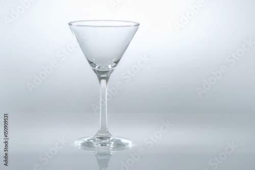 Blank glass of martini on white background