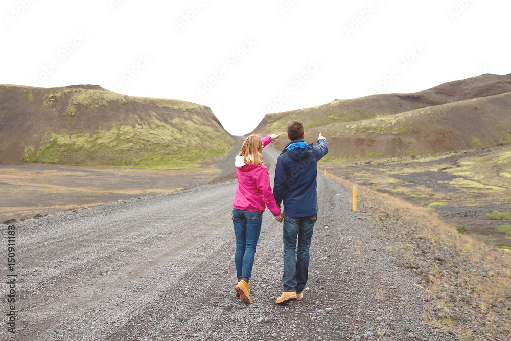 Couple stand in the middle of nowhere and hold each other hands