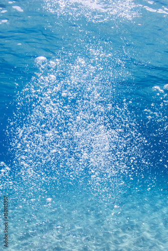 Oxygen bubbles in blue clear water