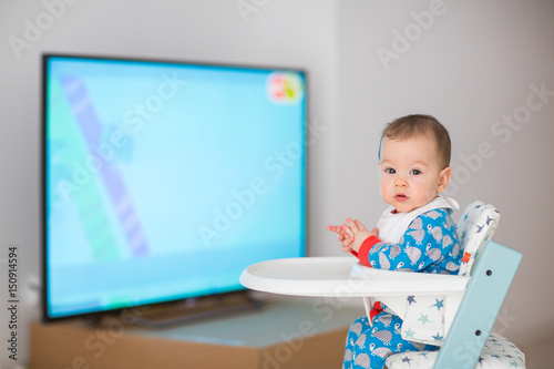 Baby watching cartoons on TV (6 months old).