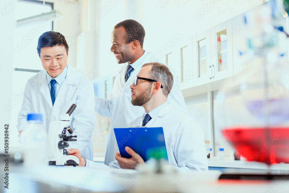 young doctors in uniform working at testing laboratory, laboratory technicians young doctors in uniform working at testing laboratory, laboratory technicians