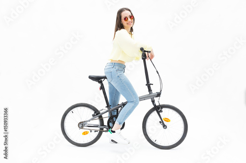 Smiling young girl on collapsible bike