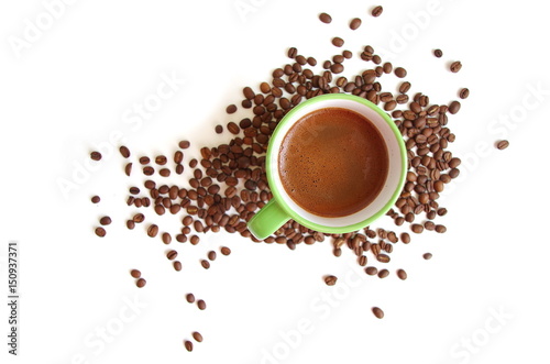 Top view of a coffee cup and coffee beans on a white background
