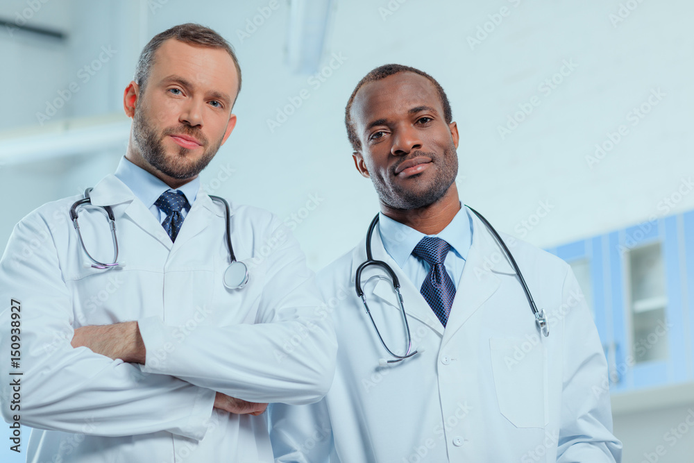 portrait of multiracial group of doctors in medical uniforms in clinic portrait of multiracial group of doctors in medical uniforms in clinic