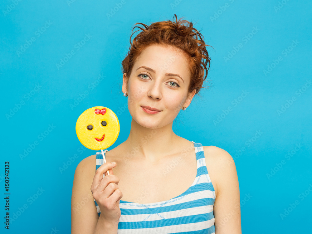 Young beautiful woman with citrus and candy on blue background Young beautiful woman with citrus and candy on blue background